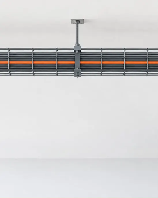A cable tray running the length of an office ceiling, carrying gray cables and one orange run.